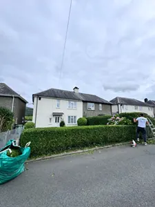 Picture showing before and after garden hedge trimming completed by Hawkins Garden Services of Tywyn